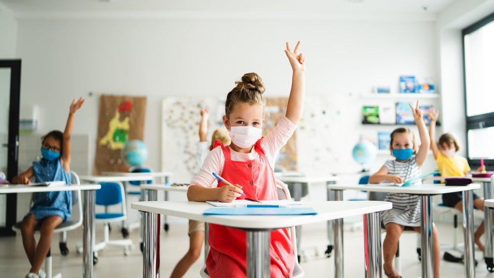 Masked students in a classroom