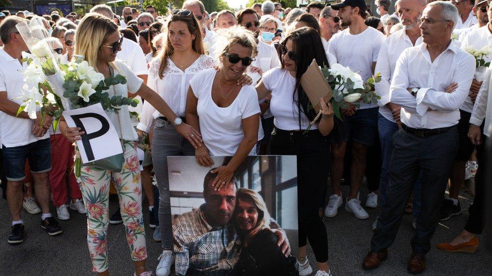 Veronique Monguillot holding a picture of her dead husband