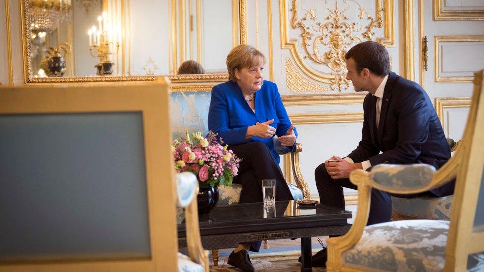 German Chancellor Angela Merkel and the French President Emmanuel Macron speak at the beginning of the Franco-German Council of Ministers at the Elysee Palace