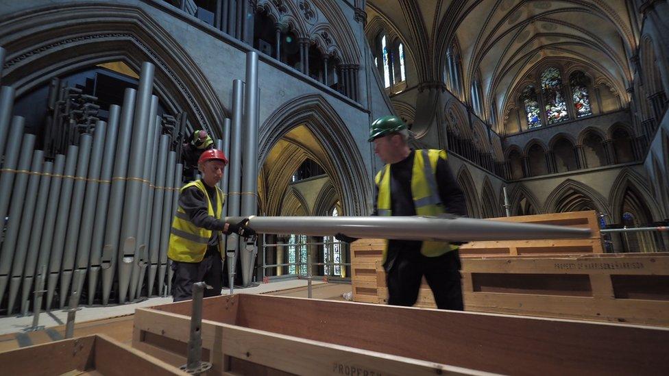 Restorers removing organ pipes