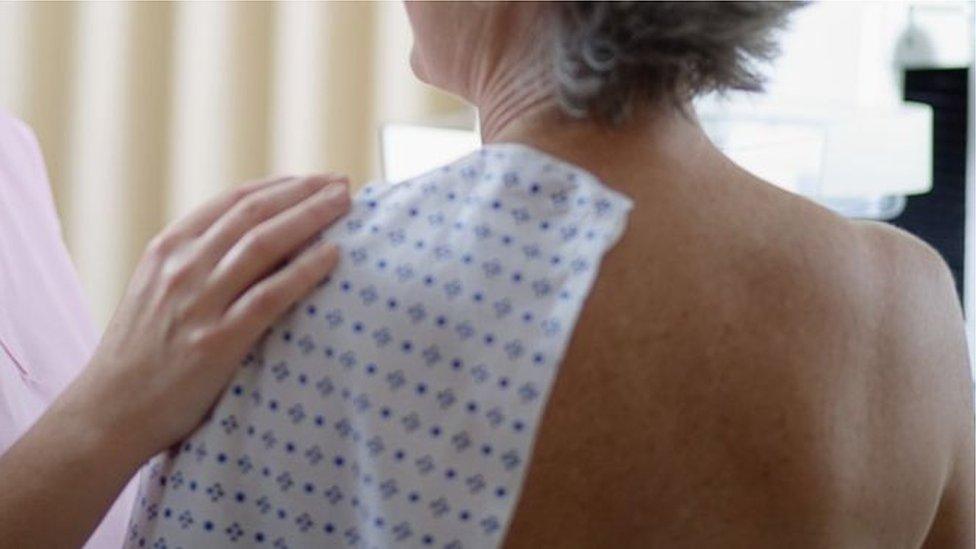 A woman in hospital gown