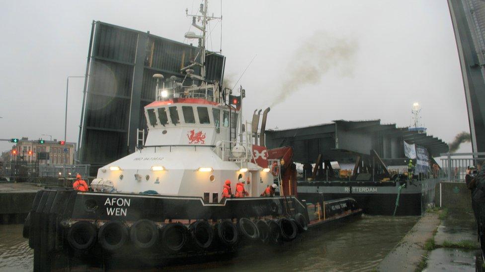 Steel piece being transported by boat.