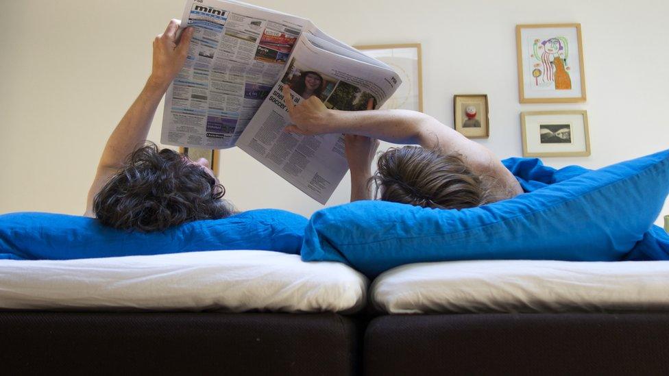 Couple reading a paper