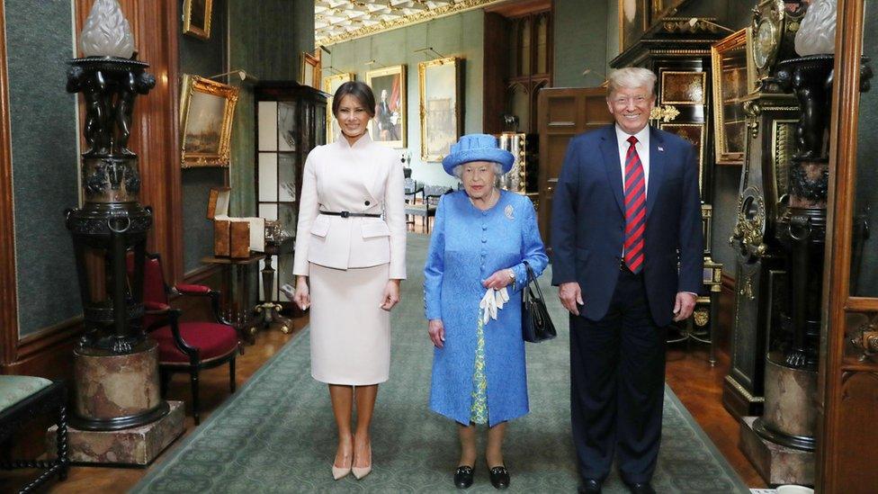 The Queen stands with Donald Trump and his wife, Melania in the Grand Corridor during their visit to Windsor Castle