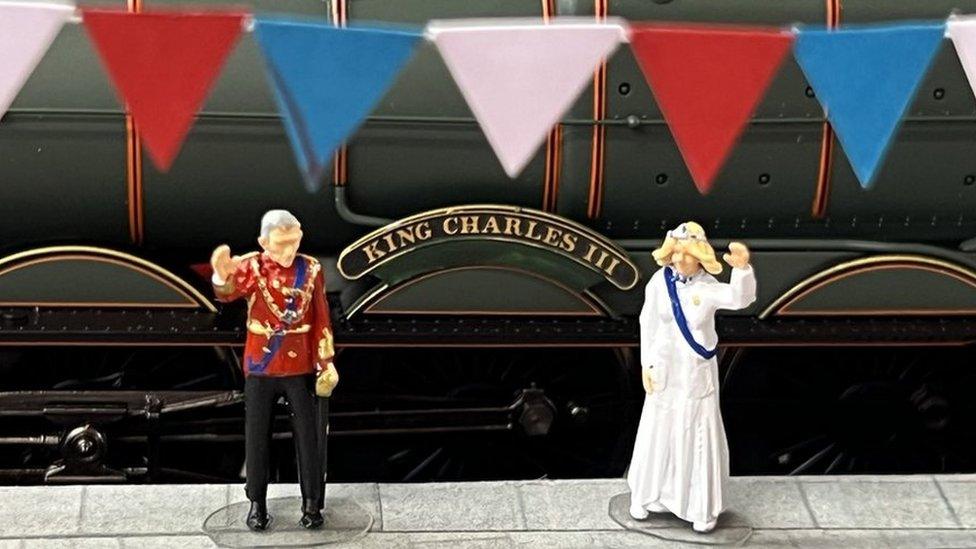 The King and Queen wave by a train called the King Charles III