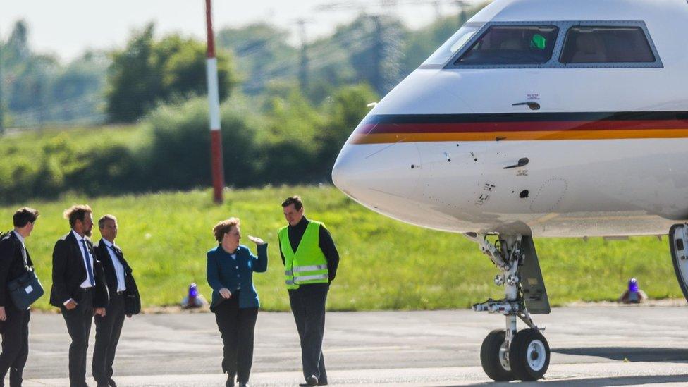 Angela Merkel pictured with the plane before it was damaged