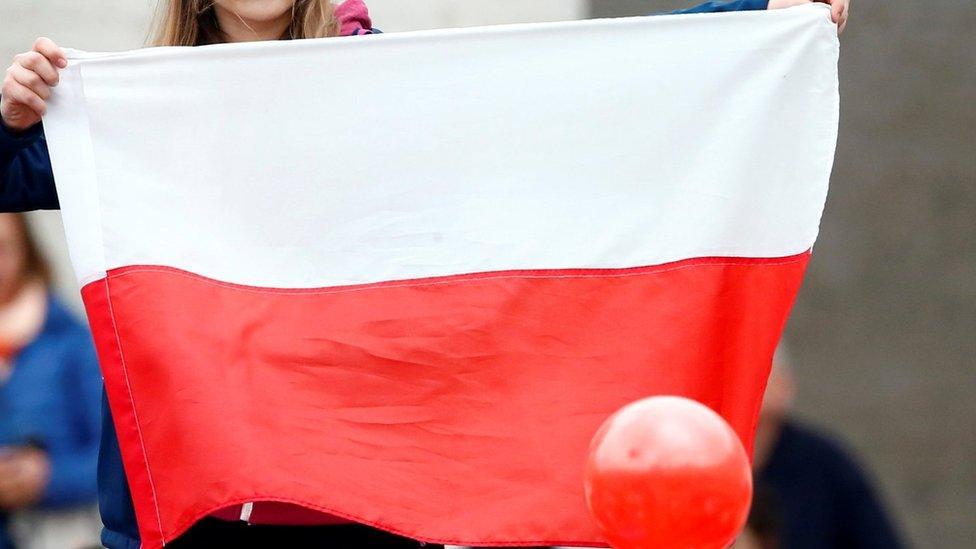 Woman holding a Polish flag