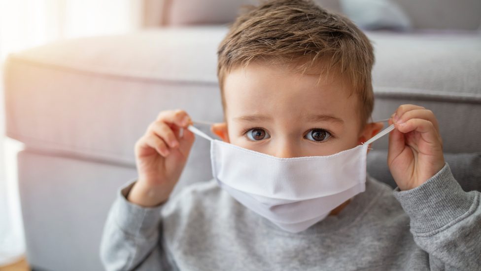 young boy wearing a face mask