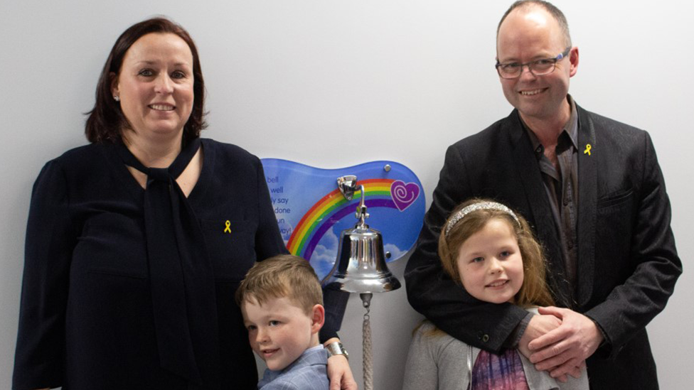 Carter with his sister and mum and dad in a corridor at Birmingham Children's Hospital 