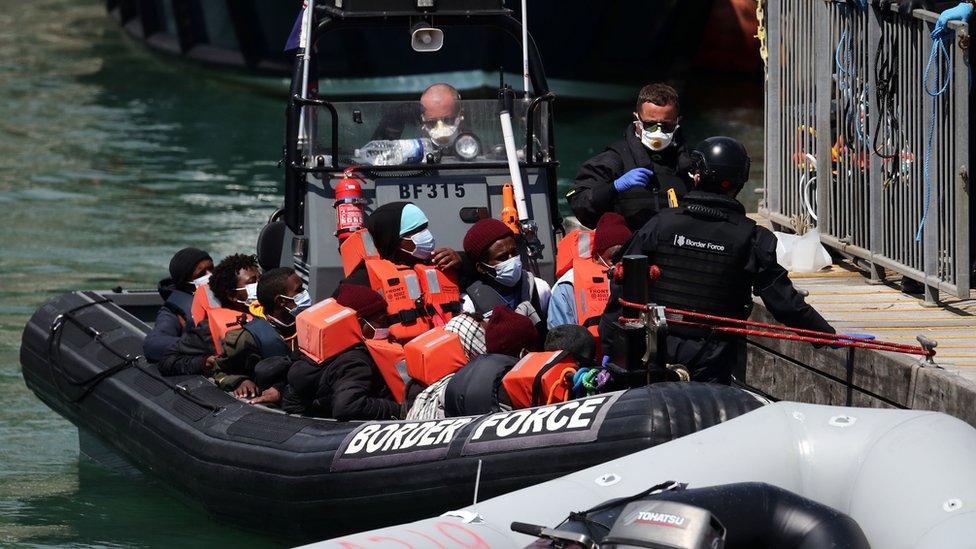 A group of people thought to be migrants are brought in to Dover, Kent