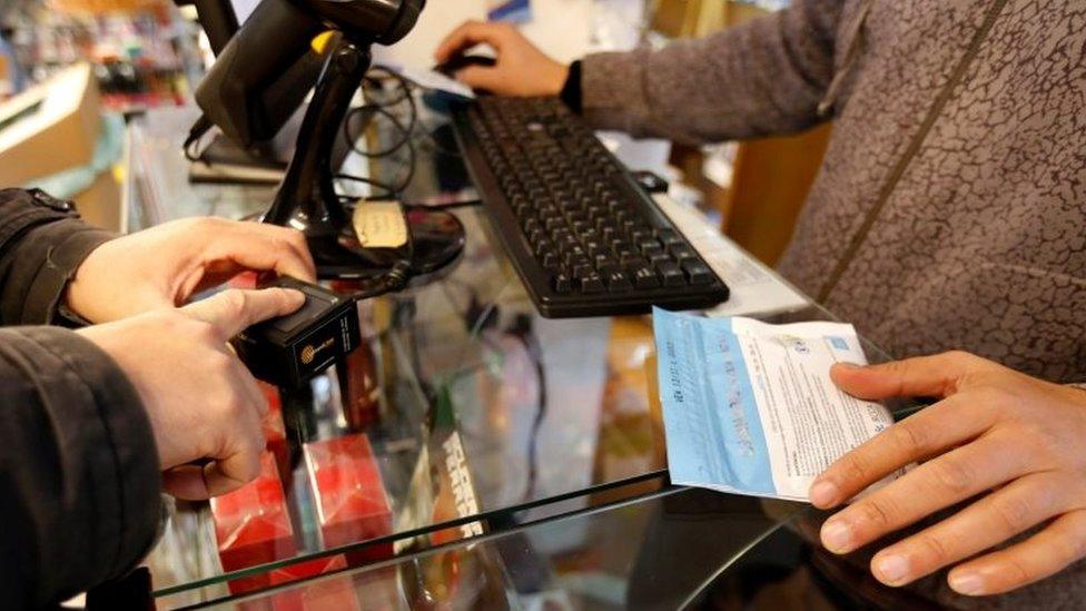 A man has his identity checked with a digital scanner before buying legal marijuana in a pharmacy in Montevideo, Uruguay July 19, 2017.