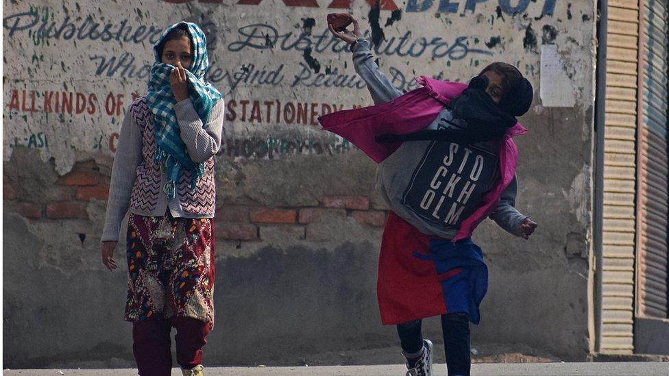 A female protester throws stones during clashes in Srinagar, Kashmir, on October 29, 2019