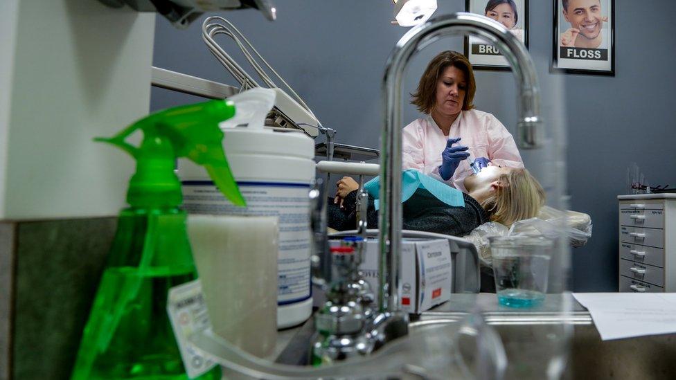 Dentist cleans patients teeth