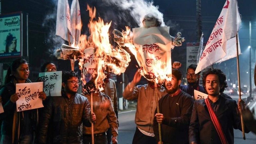 Activists of Students" Federation of India (SFI) burn the effigies of India's Prime Minister and Chief Minister of Assam in Guwahati on January 8, 2019 after India's lower house passed today legislation that will grant citizenship to members of certain religious minorities but not Muslims