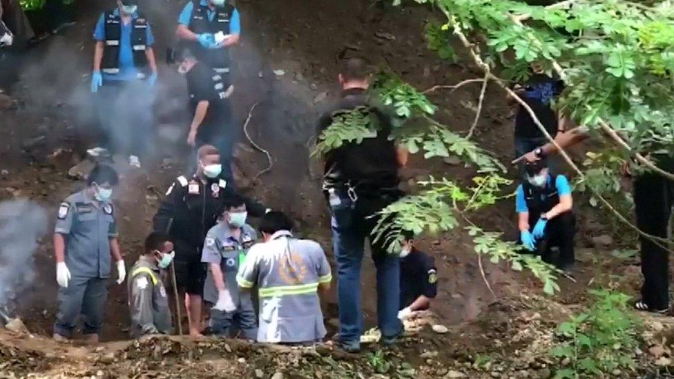 Forensic experts and police excavate the bodies of Alan Hogg and his Thai wife in Phrae, northern Thailand