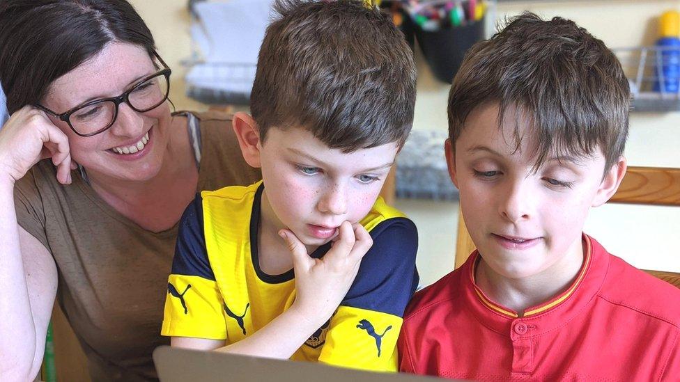 Ruth Moore shows her sons how to code