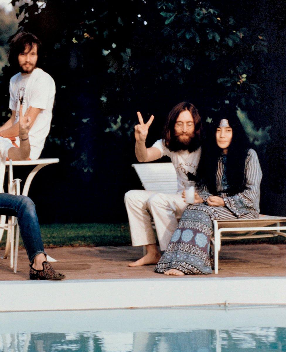 Klaus Voormann and John and Yoko, relaxing by the pool, the morning after a show in Canada , 1969