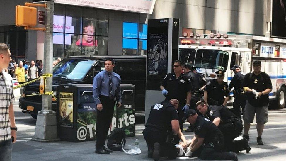 First responders are assisting injured pedestrians after a vehicle struck pedestrians on a sidewalk in Times Square in New York.