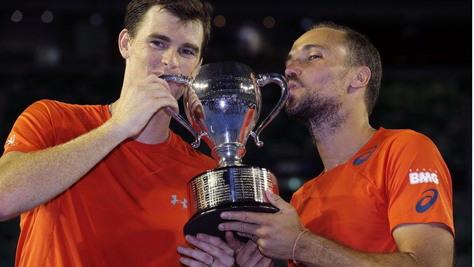 Jamie Murray, left, of Britain and Bruno Soares of Brazil hold their trophy after defeating Daniel Nestor of Canada and Radek Stepanek of the Czech Republic in the men"s doubles final at the Australian Open tennis championships in Melbourne, Australia, early Sunday, Jan. 31