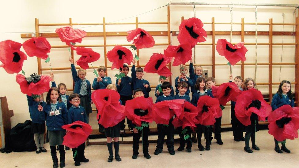 Children from Rhos St Primary School with poppies