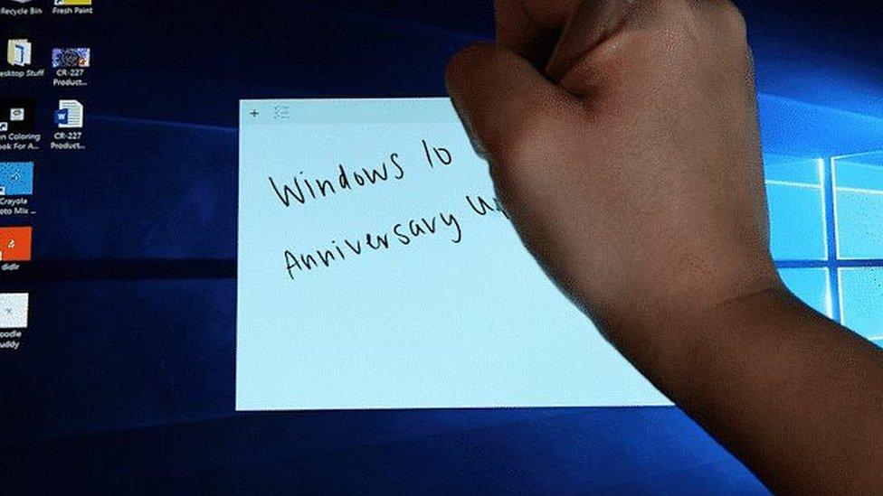 A pen writing on a Windows 10 tablet