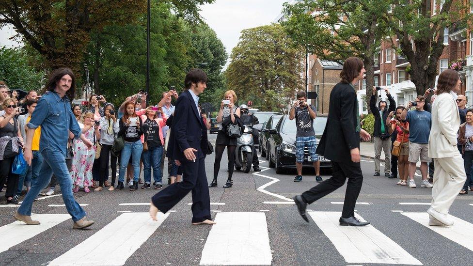 The cast of the West End show Let It Be come together on the zebra crossing outside Abbey Road Studios