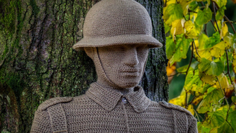 The head and shoulders of a crochet soldier