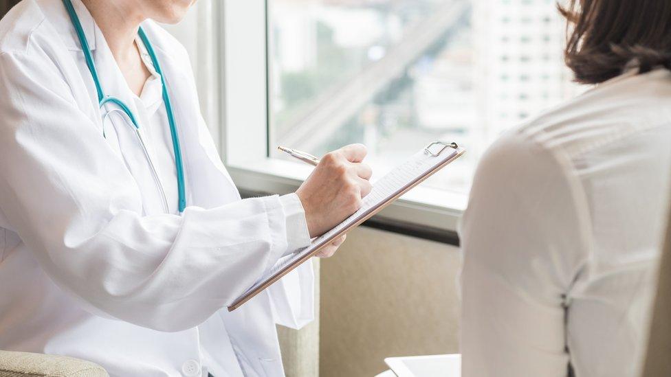 Woman going for screening and talking to a doctor