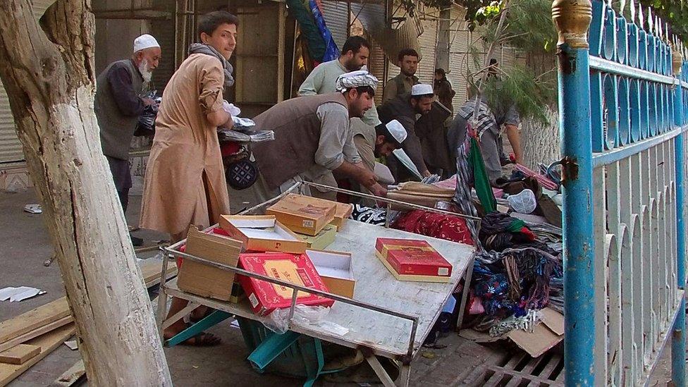 Afghan vendors sort their properties in a street of Kunduz city, north of Kabul, Afghanistan, Thursday, Oct. 1, 2015.