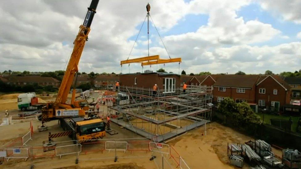 Modular home being assembled