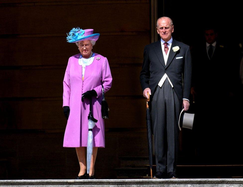 Queen Elizabeth and Prince Philip at a garden party