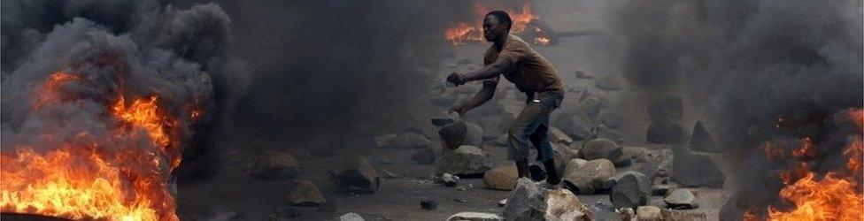 A protester sets up a barricade during a protest against Burundi President Pierre Nkurunziza and his bid for a third term in Bujumbura, Burundi, in this May 22, 2015