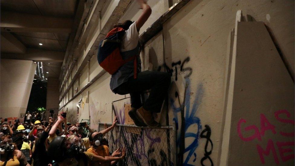 Demonstrators try to break into a federal building during a protest against racial inequality, police violence, and the presence of federal law enforcement officers, Portland, Oregon