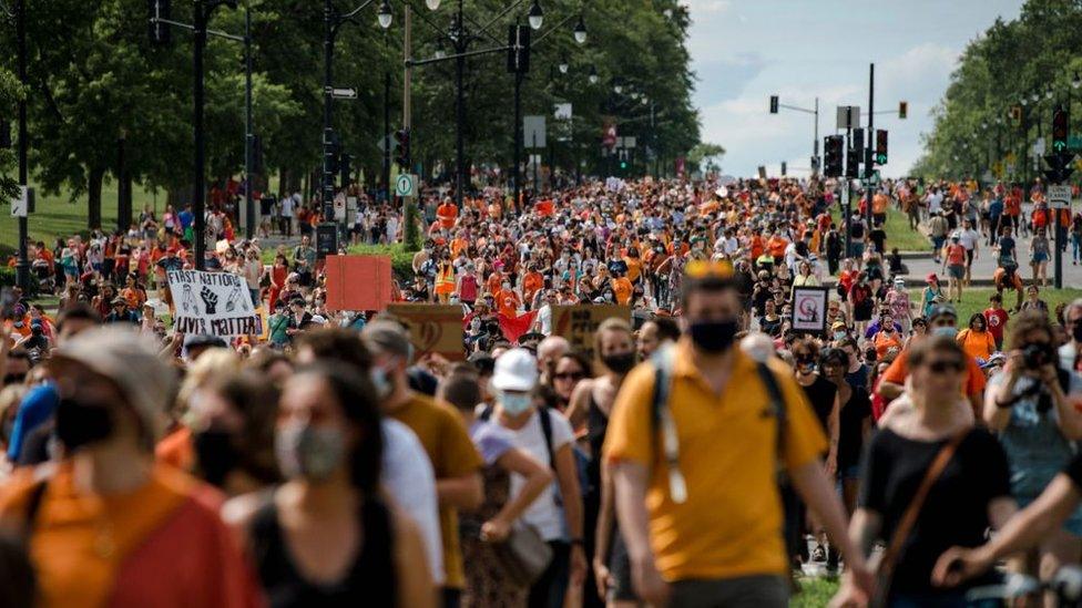 People from the indigenous community and others gather at the Cartier Statue by Mont Royal in Montreal, Quebec, on July 1, 2021