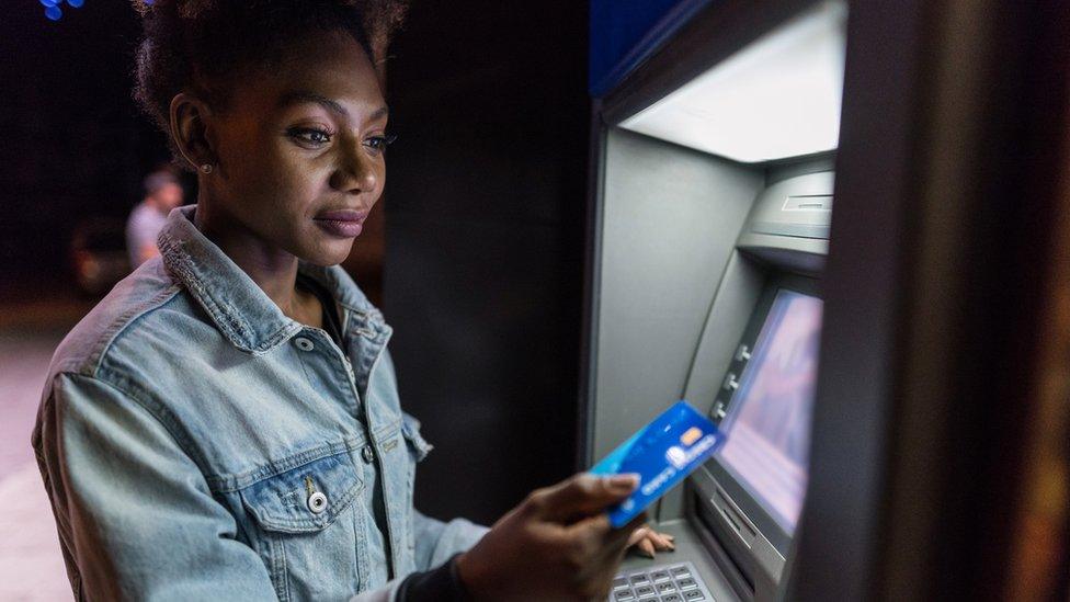 Woman using ATM