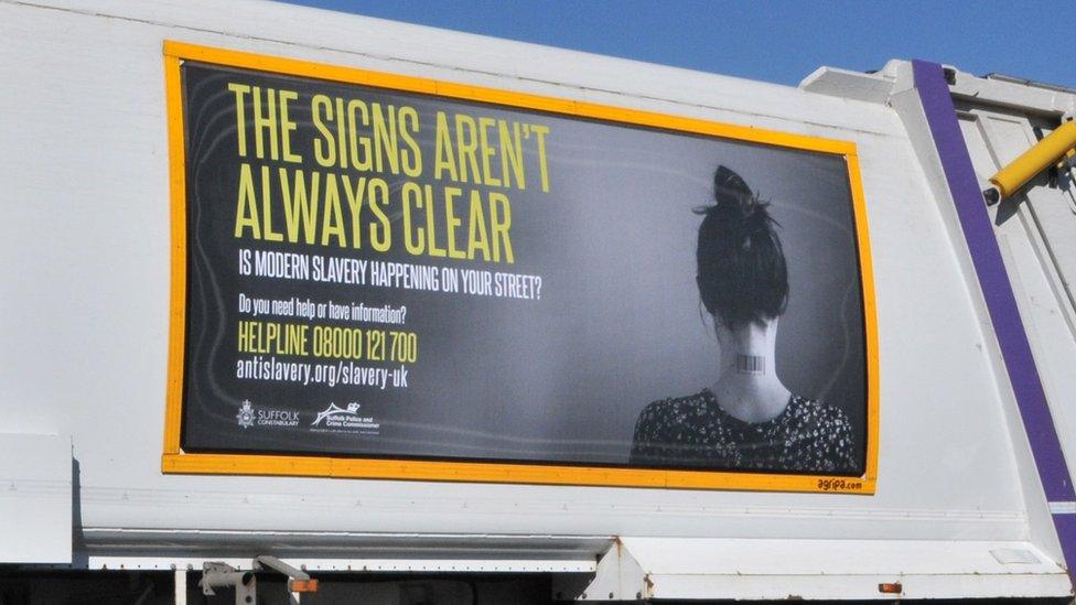 Modern slavery poster on bin lorry