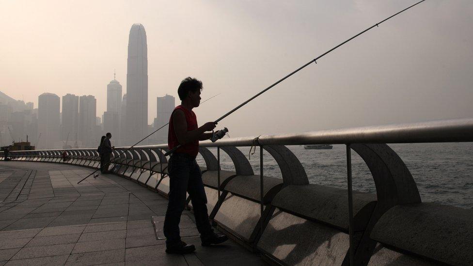 Men fishing in Hong Kong's Victoria Harbour