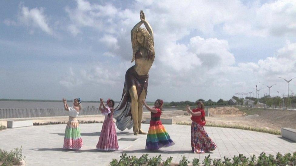 Dancers celebrate at the unveiling of the new Shakira statue in Barranquilla on 26 December