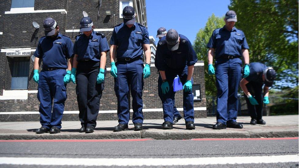 A police search team at the scene outside Aberfeldy House in Camberwell New Road