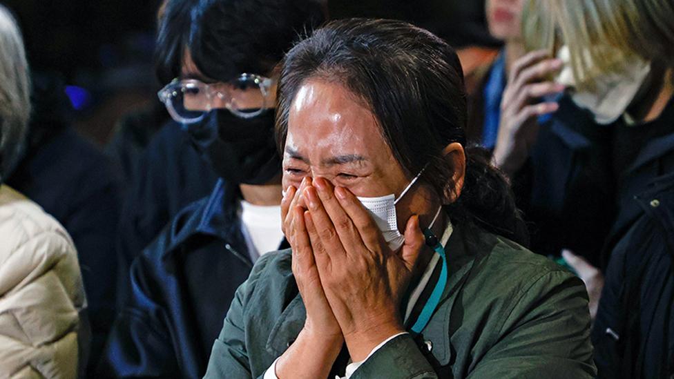 People cry during tribute for the victims of the Halloween disasters in Itaewon on November 01, 2022