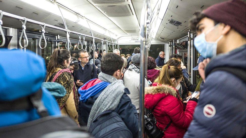 people on a bus with masks