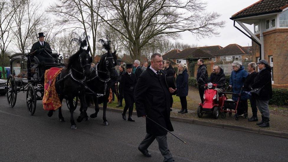 Members of the public line the street as Leah Croucher's hearse passes through on it's way to Crownhill Crematorium