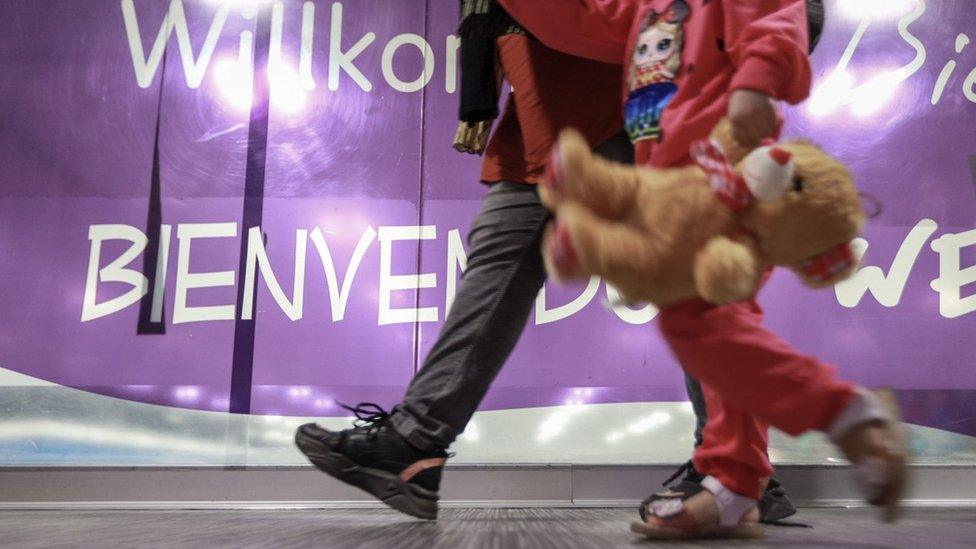 An Afghan child and adult arriving at Mexico City International Airport.