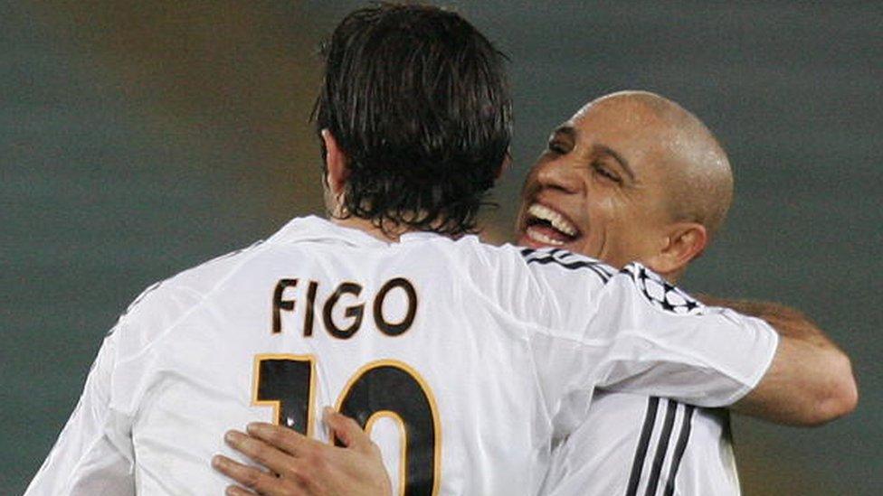 Luis Figo and Roberto Carlos celebrate a goal for Real Madrid