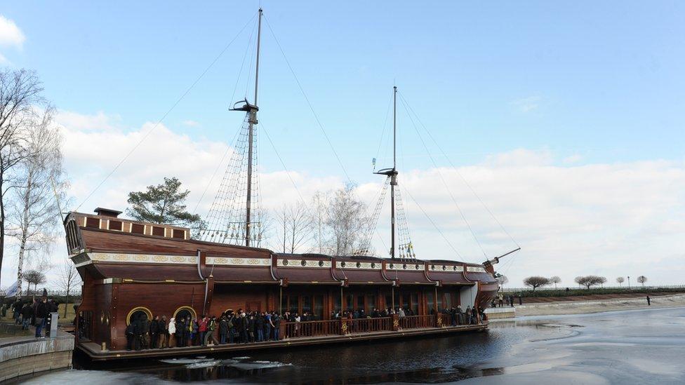 Visitors look at the boat-shaped 'Galleon' restaurant inside the compound of the luxury residence of former Ukrainian President Viktor Yanukovych, not far from Kiev on February 24, 2014