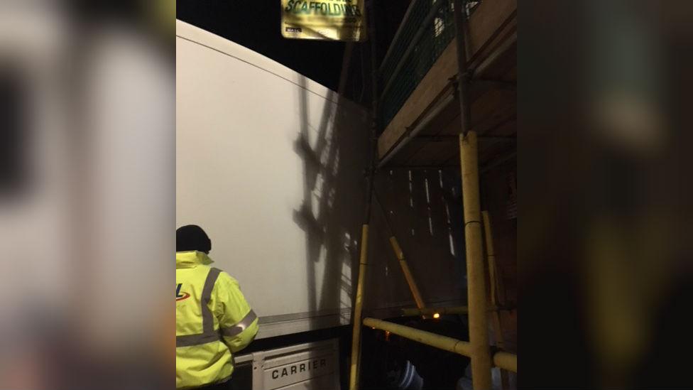 Lorry stuck on scaffolding