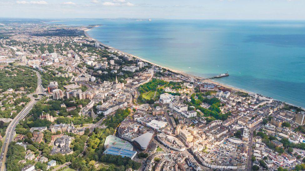 View over Bournemouth beach, pier, city and Dorset coastline on a sunny day.