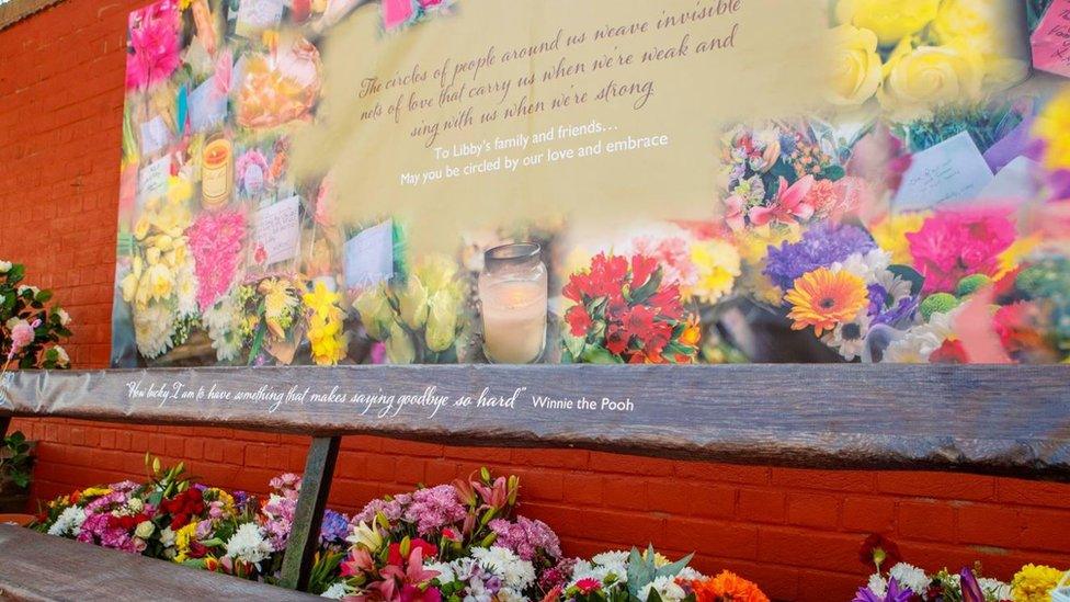 Flowers at the bench where Libby Squire was last seen