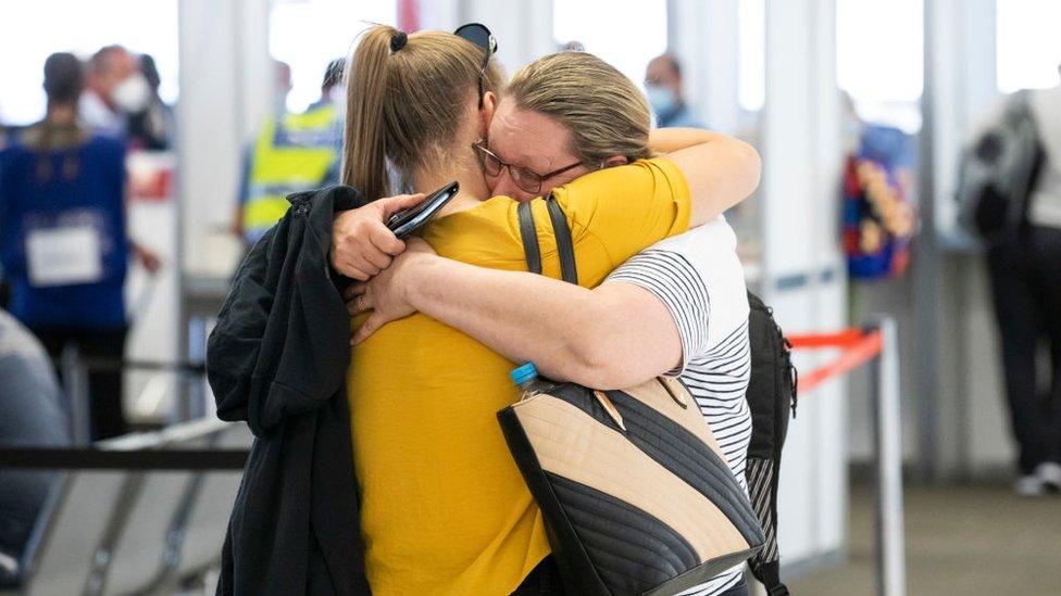 Two family members hug after reuniting at Perth Airport in December 2020 after state border closures were eased