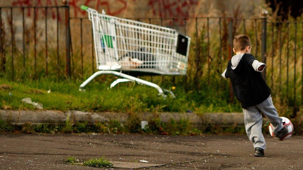 A child playing on a street in Glasgow